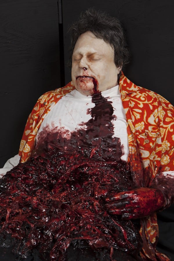 FESTER DEATH BODY CHARACTER IN SITTING POSITION FEASTING ON ORGANS