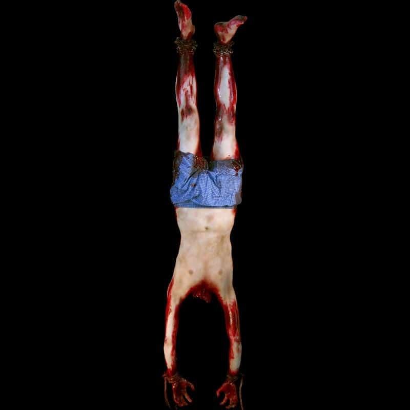 MALE DECAPITATED BODY-HUNG FROM FEET-WITH CHAIN-BLOODY FINISH